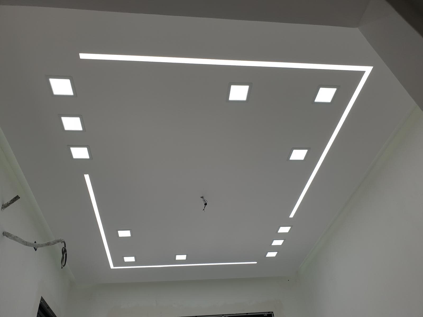Recessed LED panels and cove lighting in a custom drywall ceiling