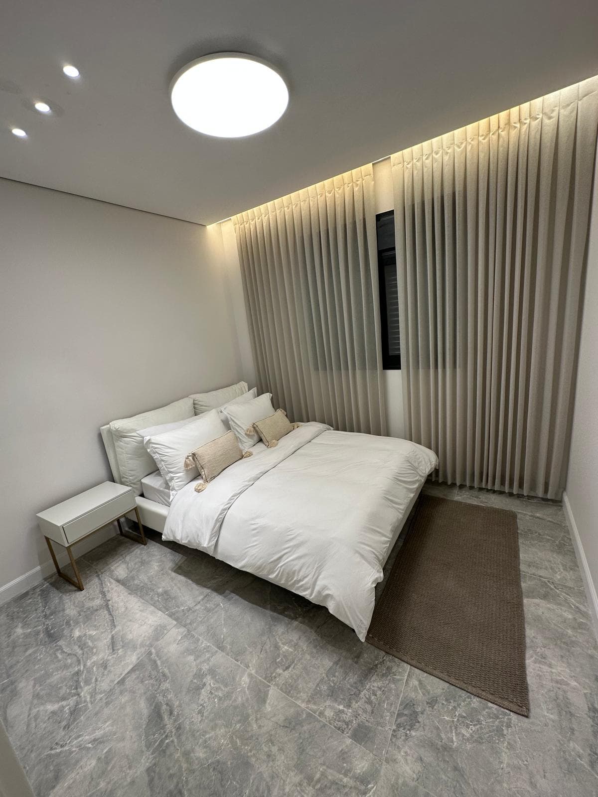 Finished bedroom with cove lighting and smooth painted walls