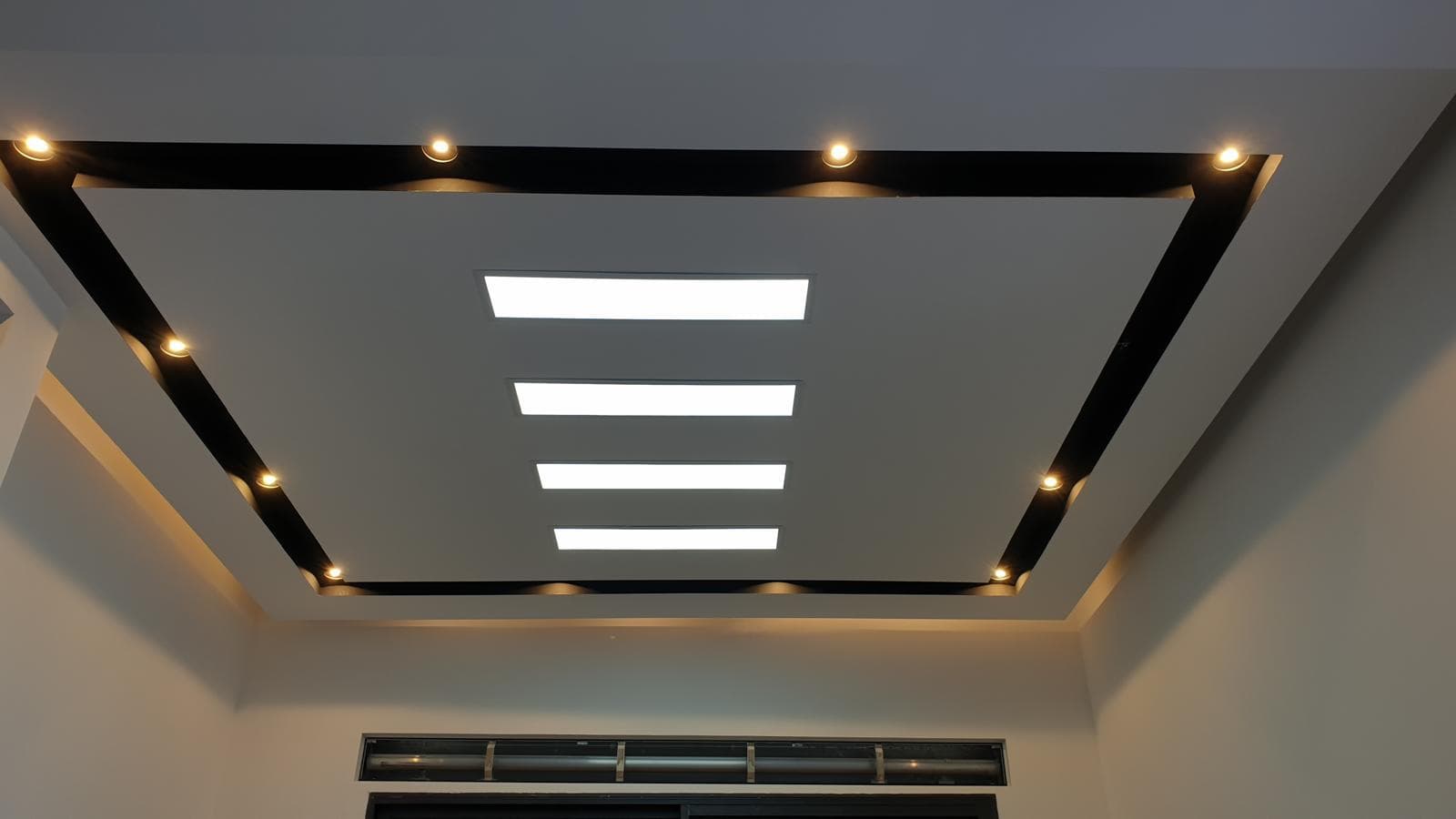 Custom recessed ceiling with trim detail and layered LED lighting