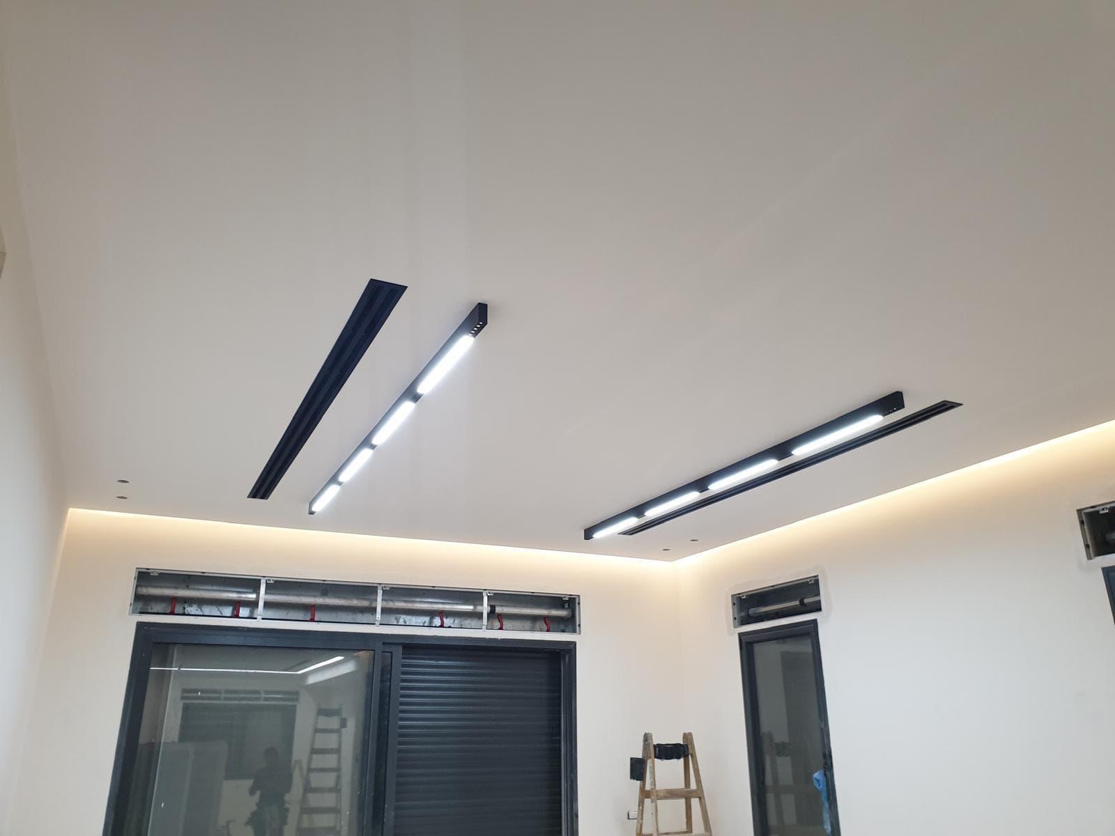 Smooth drywall ceiling with linear track and cove accent lighting