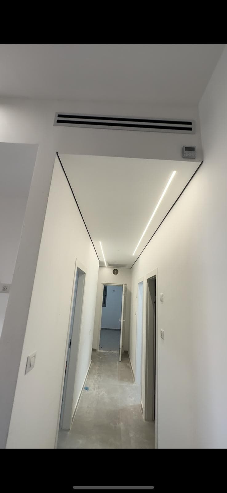 Bright hallway with crisp painted walls and recessed lighting