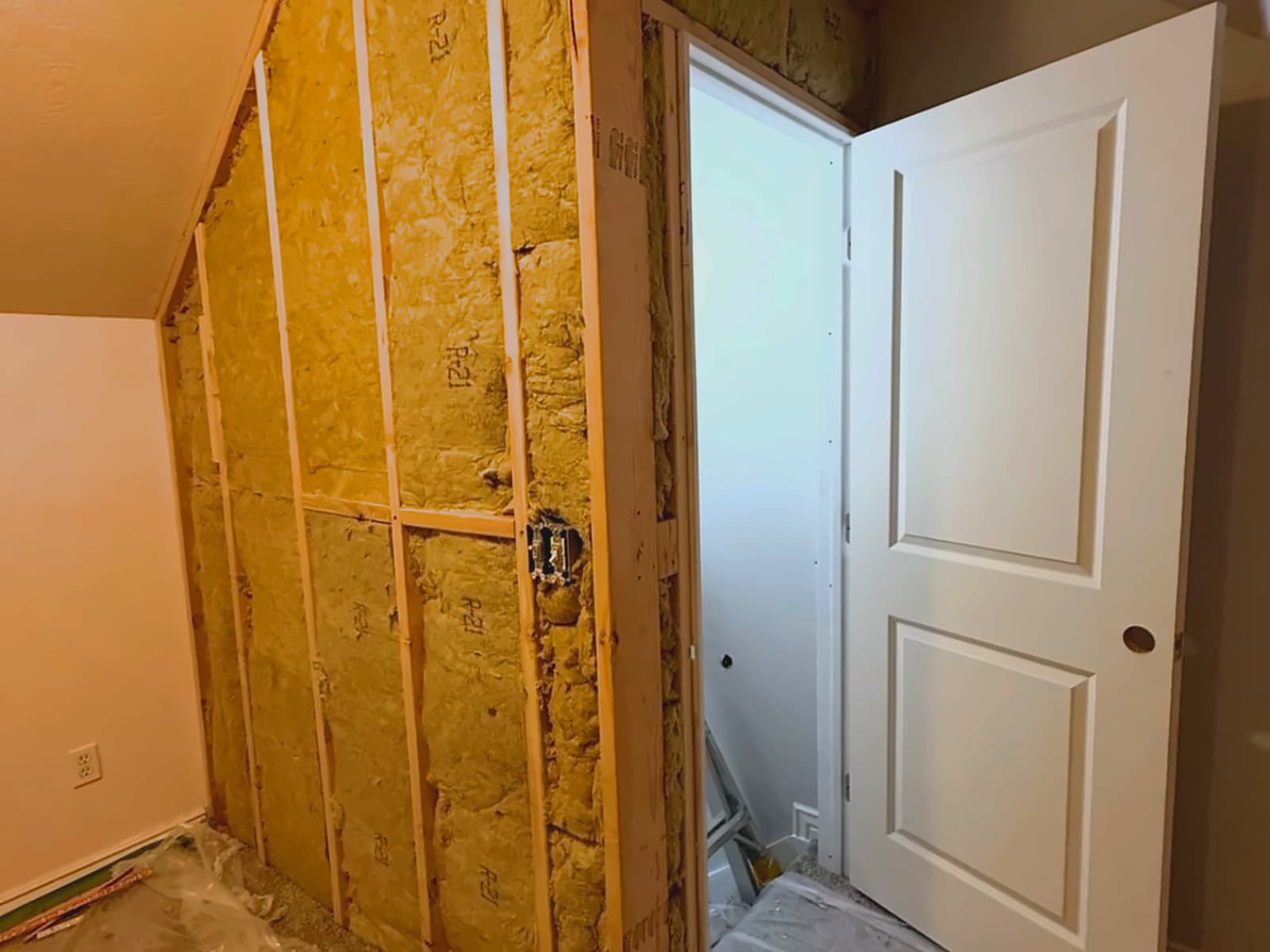 Open framing and sheathing, the ceiling slope unresolved.