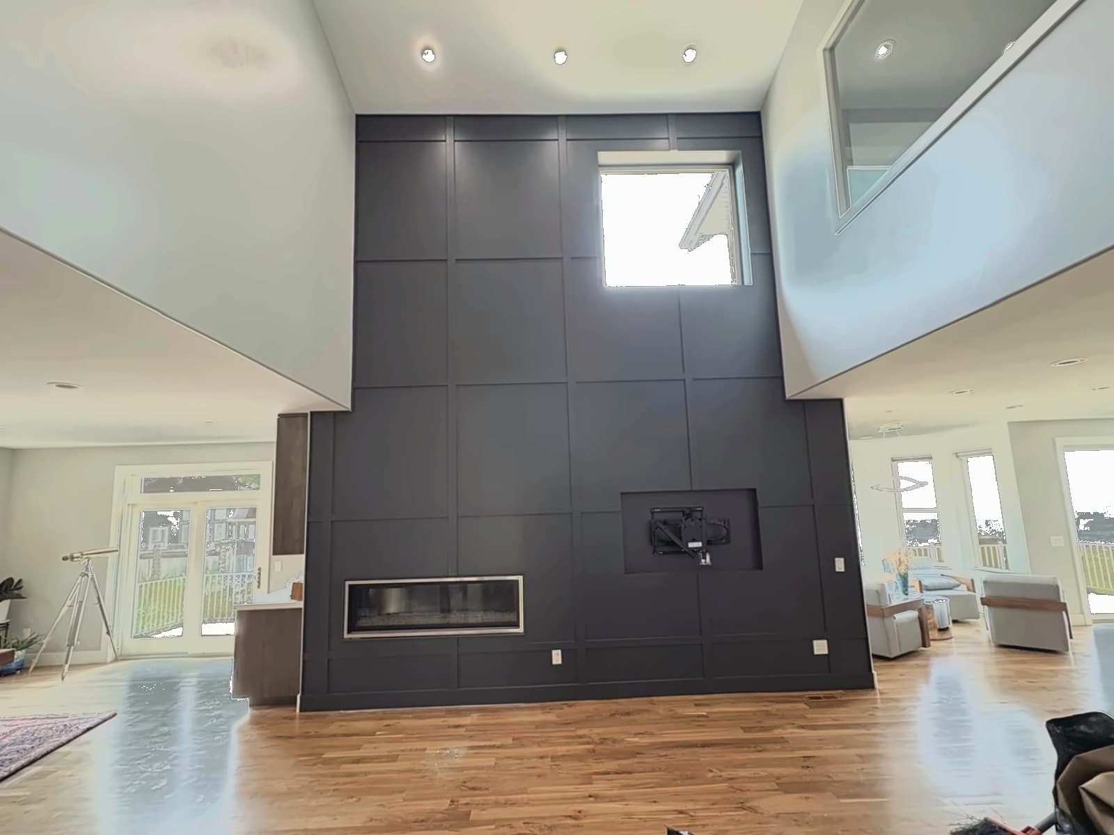 Large-format panels set flush, seams even the full height, hearth line square to the floor.